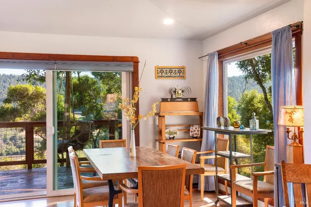 a dining room with furniture a rug and wooden floor