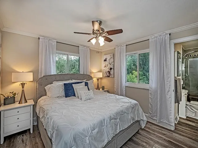 a bedroom with a large bed and a window