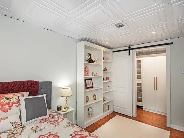 a bedroom with a bed and a dresser in it