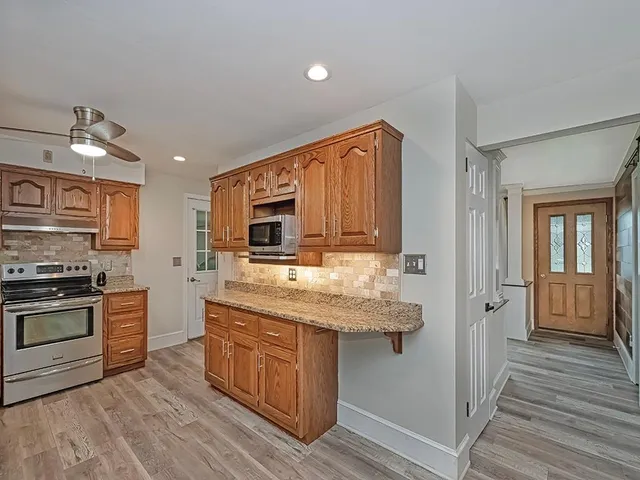 a kitchen with stainless steel appliances granite countertop a stove and a sink
