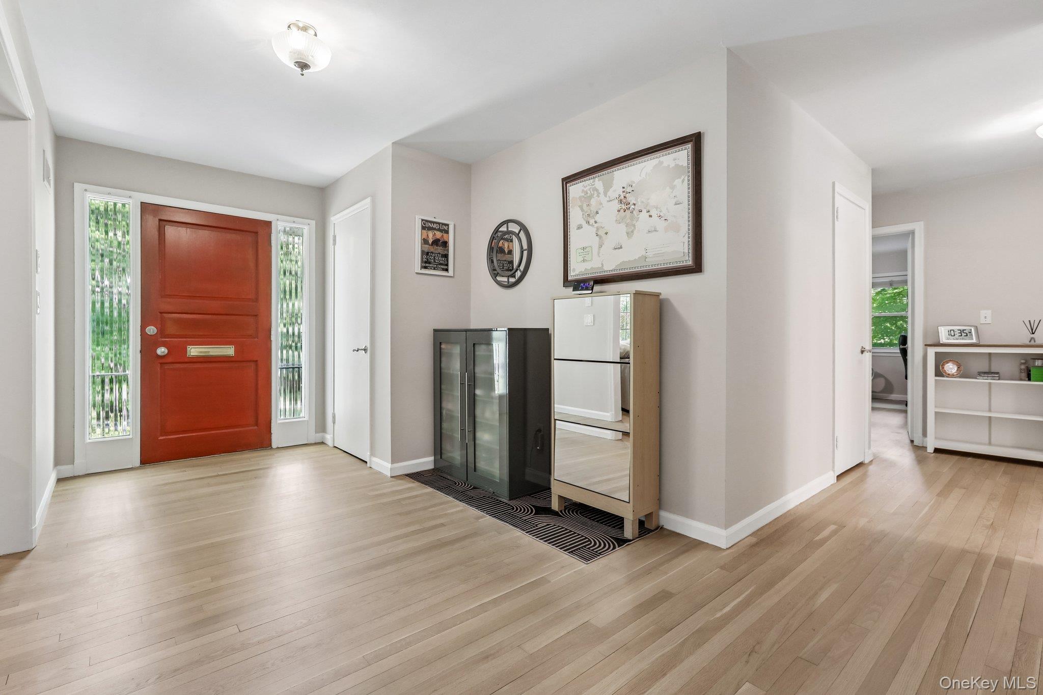 62 Mohegan Road Larchmont, NY 10538 - Photo 10 of 46 an empty room with wooden floor and way to kitchen