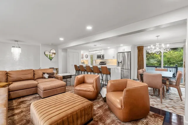 a spacious bedroom with a bed a couch and dresser