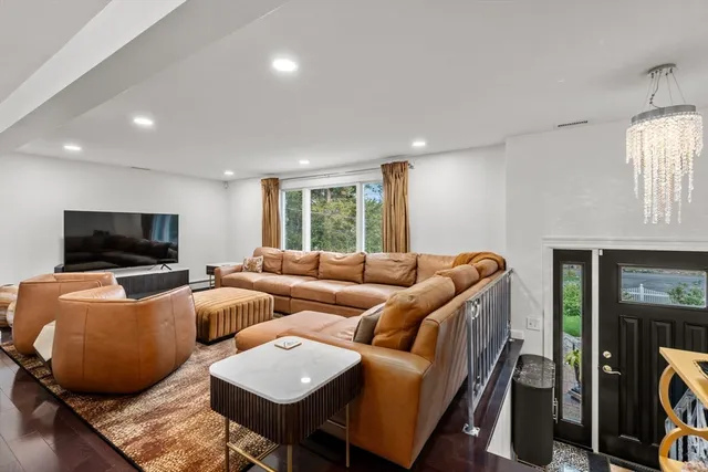 a living room with furniture and a chandelier