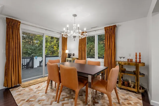 a view of a dining room with furniture and chandelier