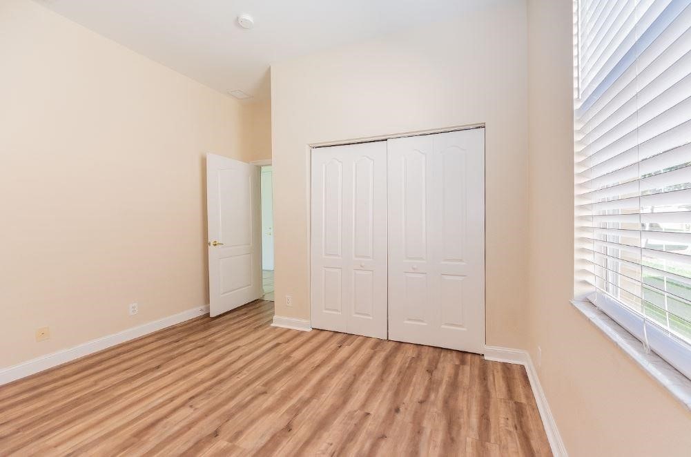 5825 Spanish River Road Fort Pierce, FL 34951 - Photo 20 of 36 a view of an empty room with wooden floor and a window