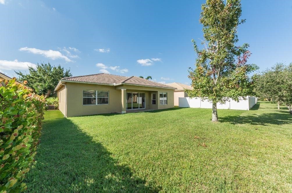 5825 Spanish River Road Fort Pierce, FL 34951 - Photo 23 of 36 a front view of a house with a garden