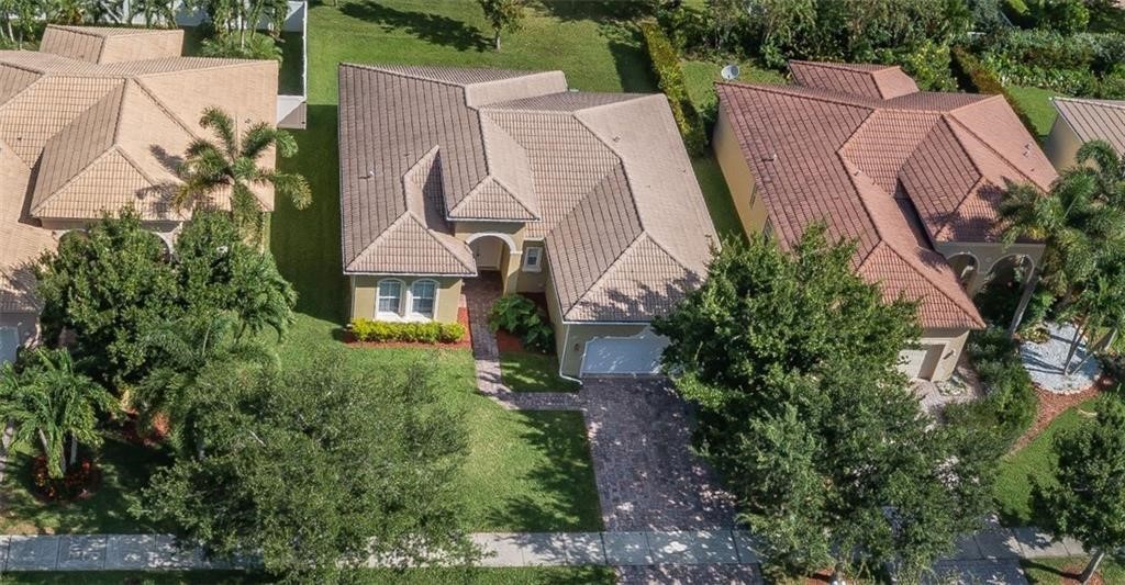 5825 Spanish River Road Fort Pierce, FL 34951 - Photo 25 of 36 an aerial view of a house with a yard and trees