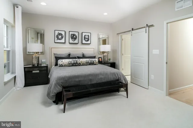 a bedroom with a bed dresser and a window