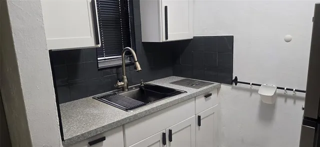 a view of an empty room with window and stairs