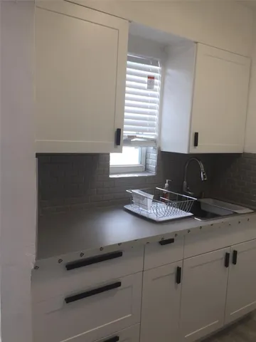 a kitchen with a refrigerator and a counter top