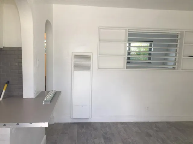 a kitchen with a sink a stove a refrigerator and a window