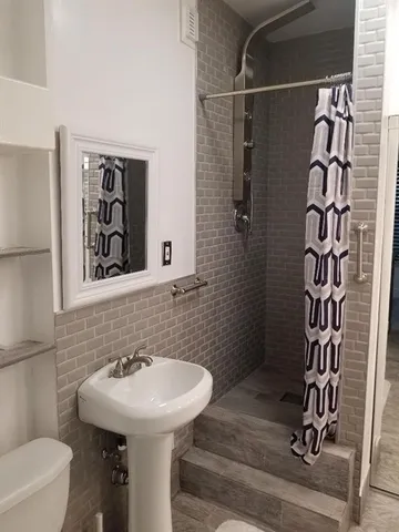 a view of a hallway with stairs and a window