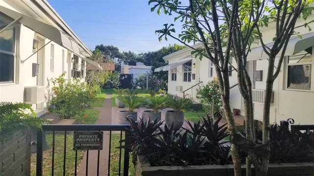 a view of a house with a tree in the background