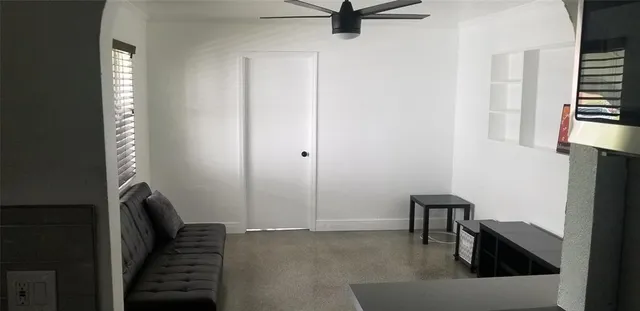 a view of a livingroom with furniture and staircase