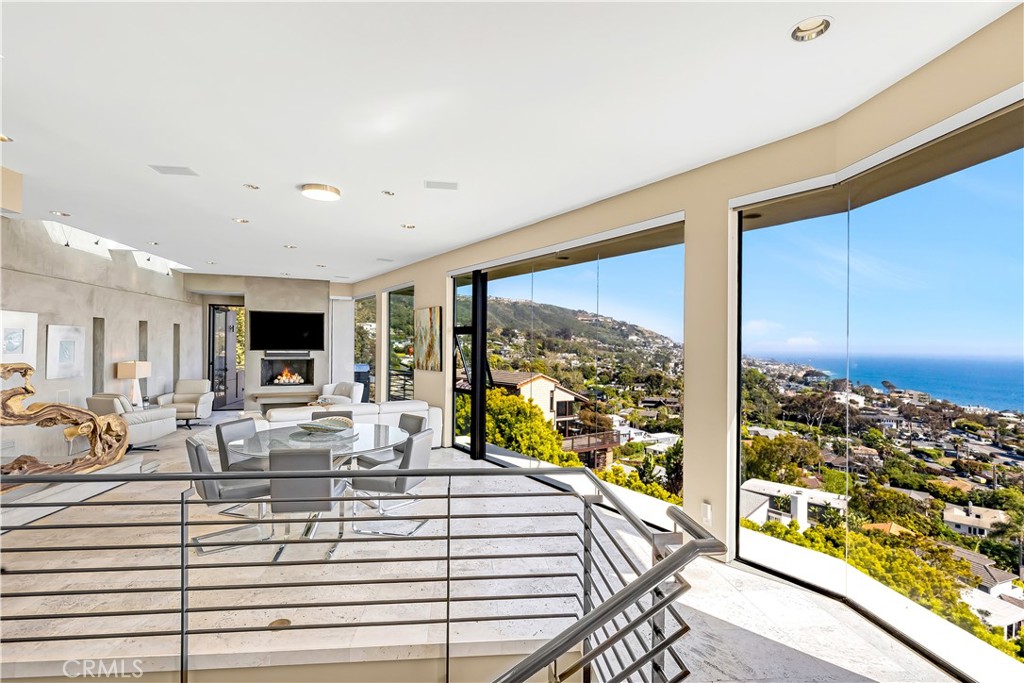 31411 Ceanothus Drive Laguna Beach, CA 92651 - Photo 14 of 60 a living room with large windows and a flat screen tv