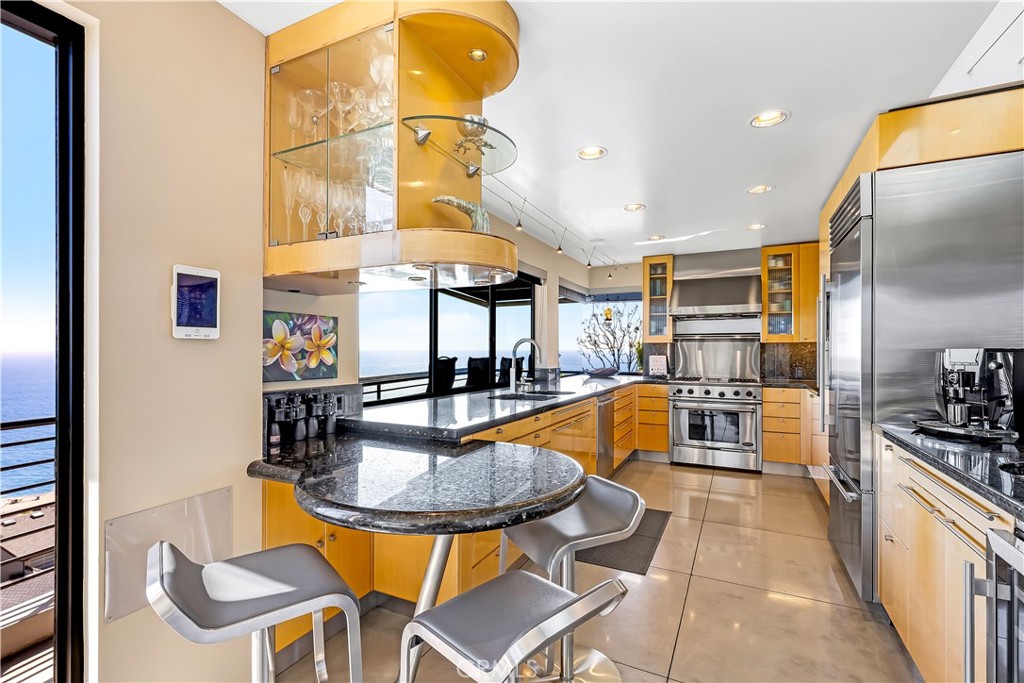 31411 Ceanothus Drive Laguna Beach, CA 92651 - Photo 15 of 60 a kitchen with stainless steel appliances granite countertop a sink a stove and a refrigerator