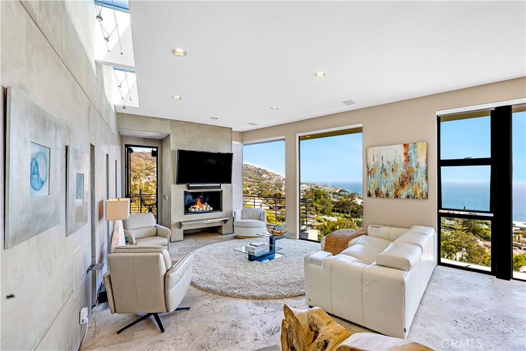 31411 Ceanothus Drive Laguna Beach, CA 92651 - Photo 6 of 60 a living room with furniture floor to ceiling window and a flat screen tv