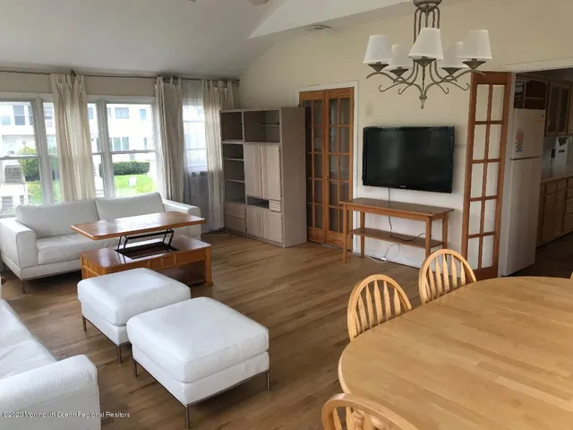 a bedroom with furniture and a flat screen tv