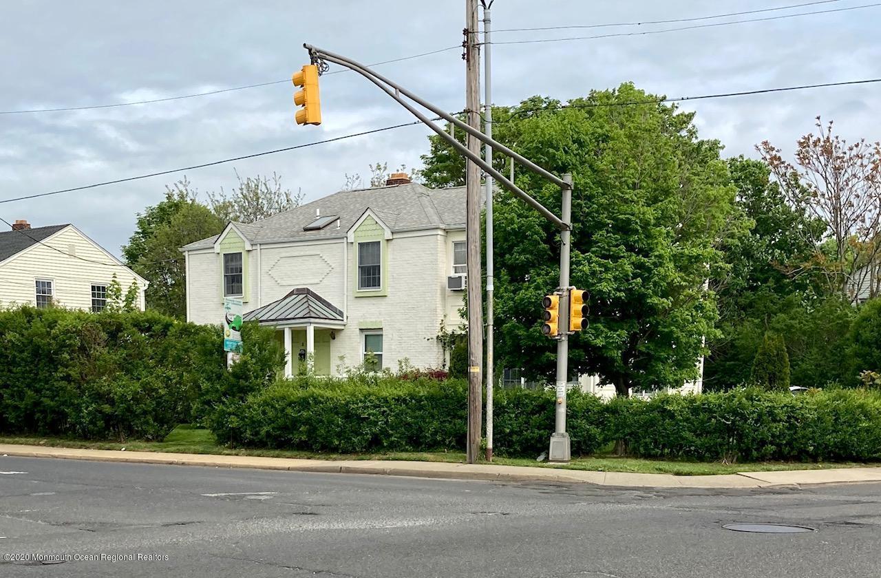 3 Cedar Avenue, Unit UPSTAIRS Long Branch, NJ 07740 - Photo 10 of 14 a front view of a house with a yard and potted plants