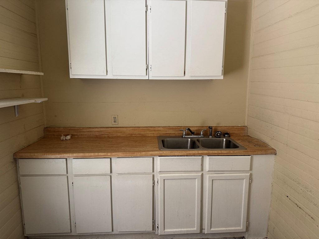 1312 22nd Street Columbus, GA 31901 - Photo 4 of 11 a kitchen with white cabinets and sink