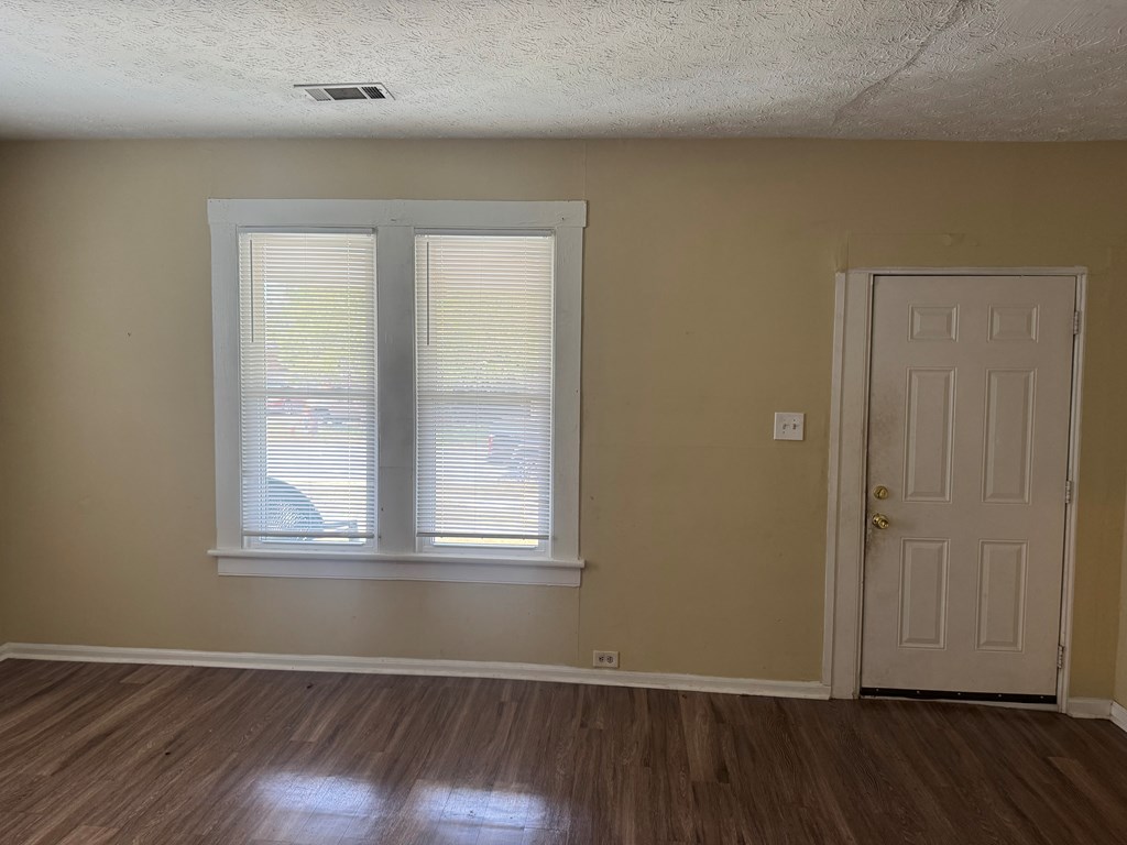 1312 22nd Street Columbus, GA 31901 - Photo 5 of 11 an empty room with wooden floor and windows