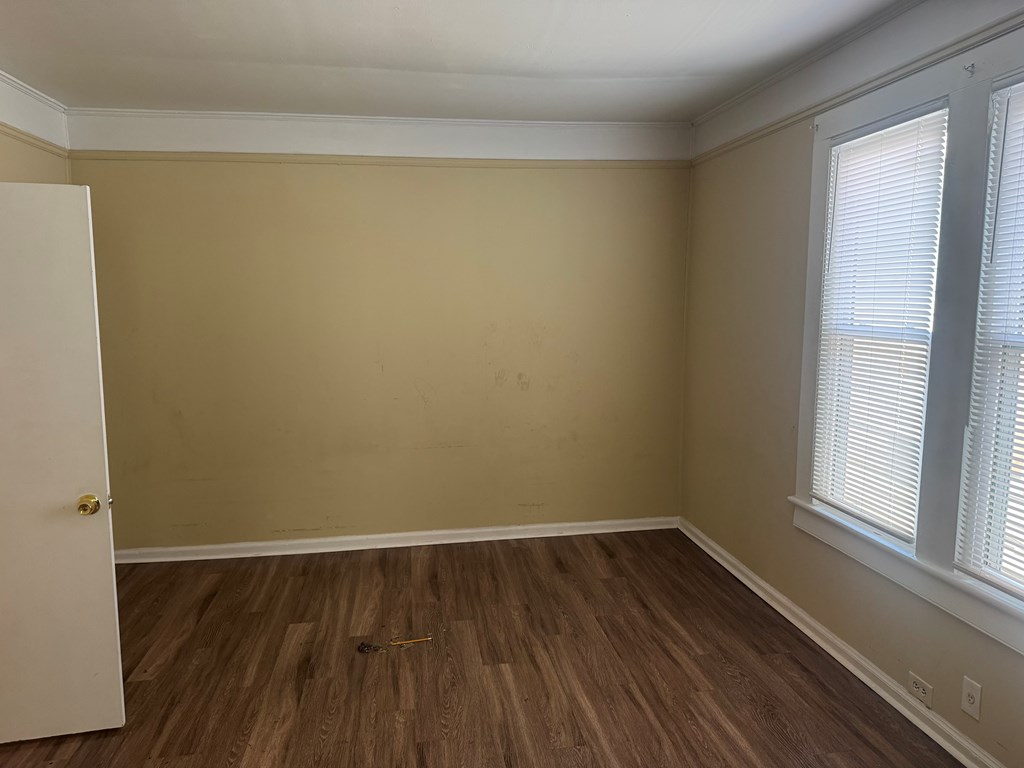 1312 22nd Street Columbus, GA 31901 - Photo 10 of 11 a view of a room with wooden floor and brick walls