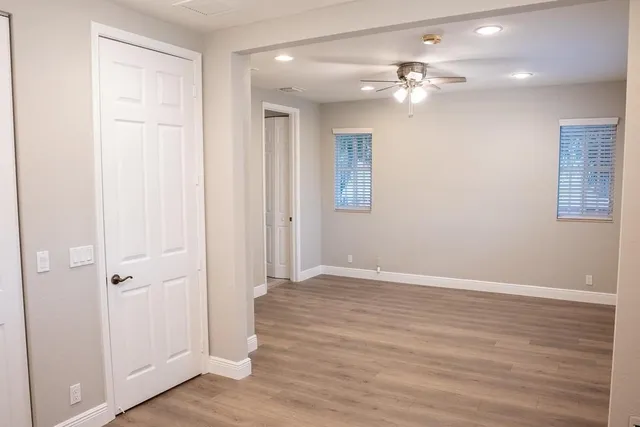 a view of an empty room with wooden floor