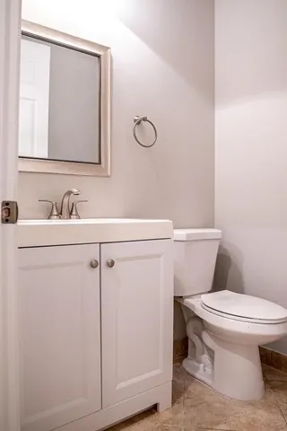a bathroom with a sink a toilet and mirror
