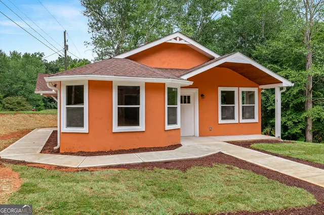 a front view of a house with a yard