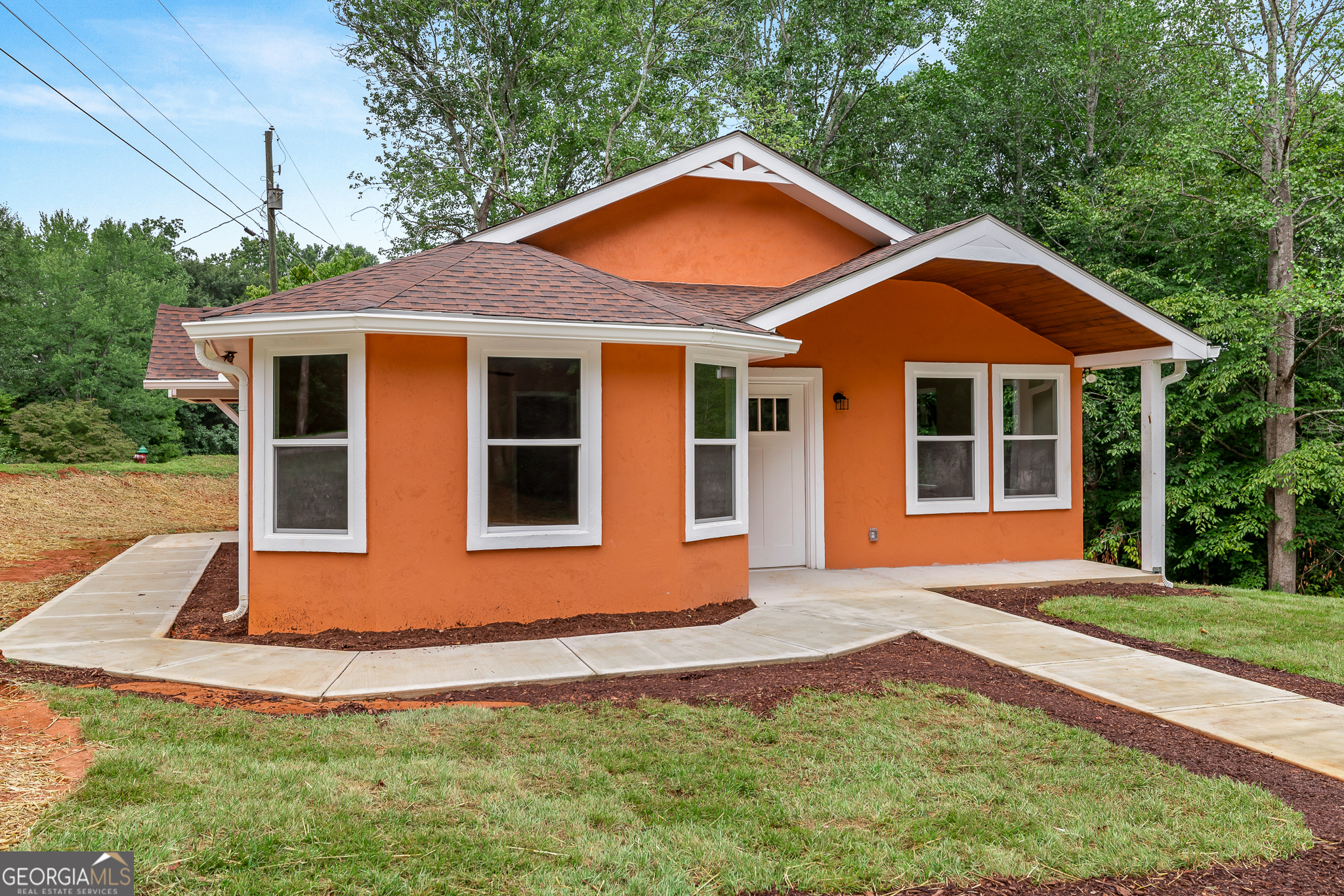 a front view of a house with a yard