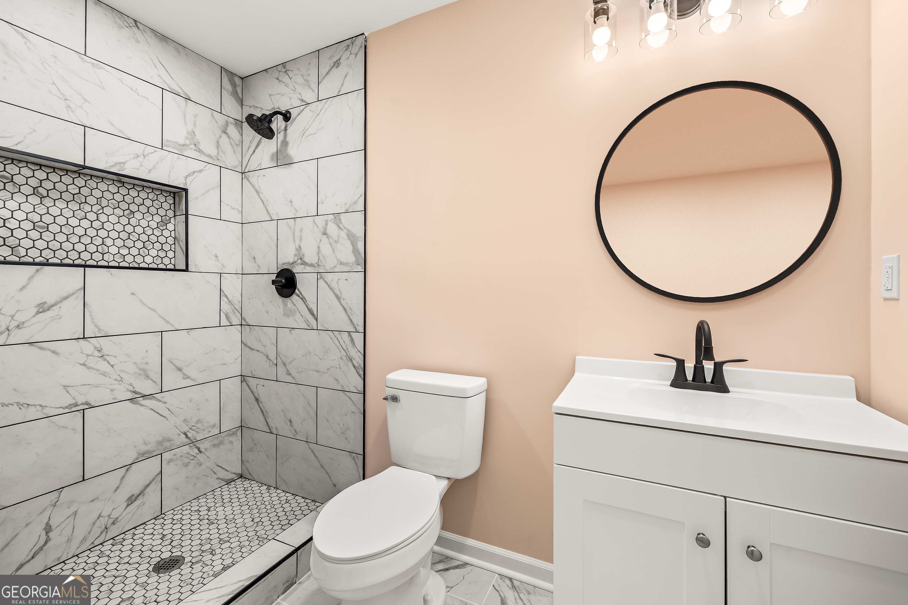 596 Watson Street Toccoa, GA 30577 - Photo 13 of 25 a bathroom with a sink a toilet and a mirror
