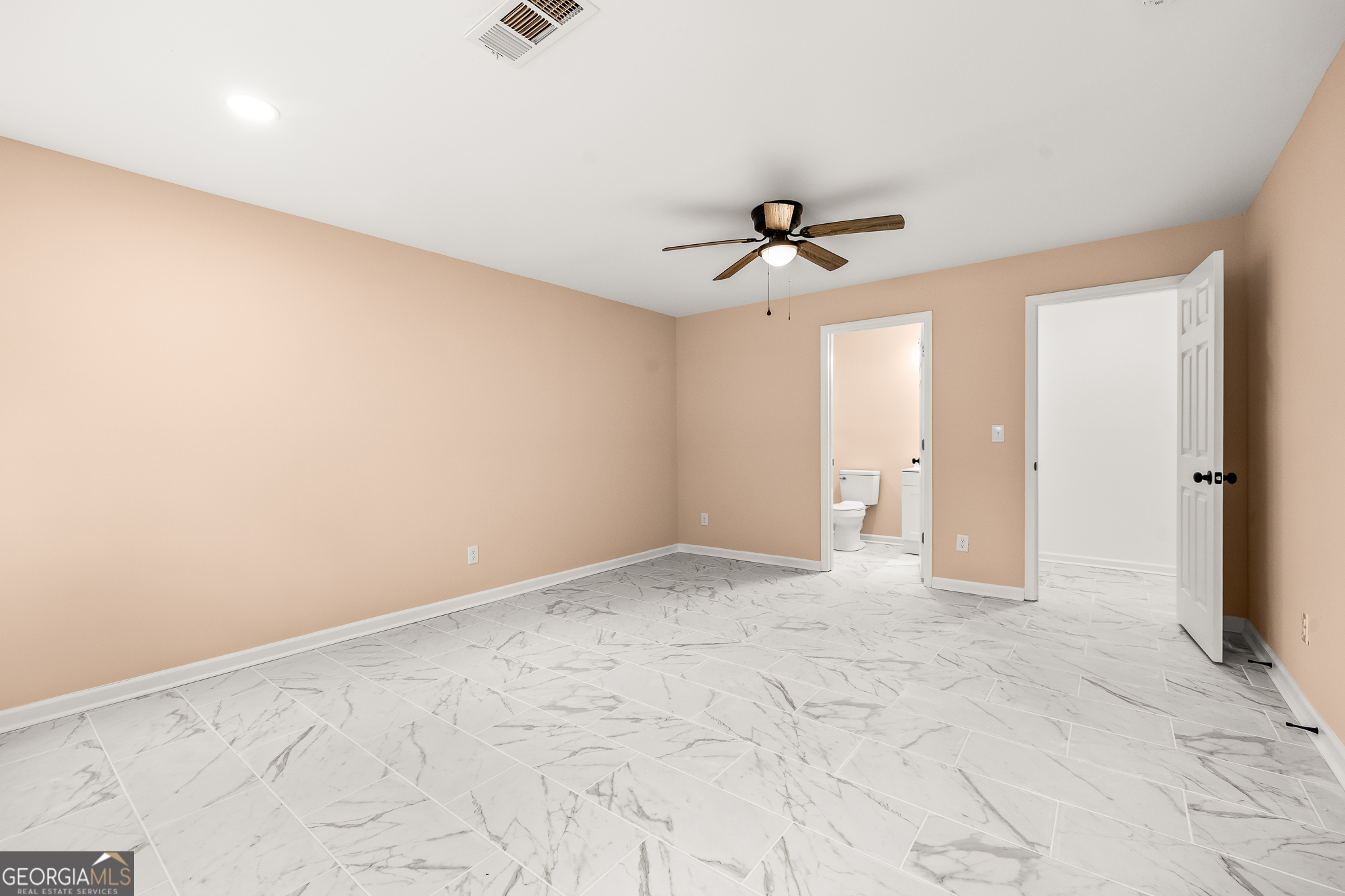 596 Watson Street Toccoa, GA 30577 - Photo 15 of 25 an empty room with chandelier fan and windows