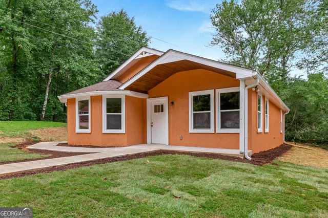 a front view of a house with a yard