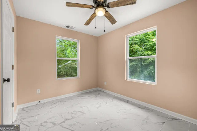 a view of an empty room with a window