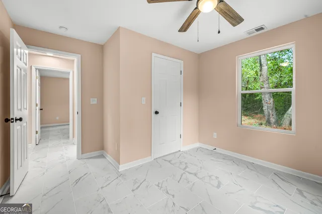 a view of a house with backyard and a tree