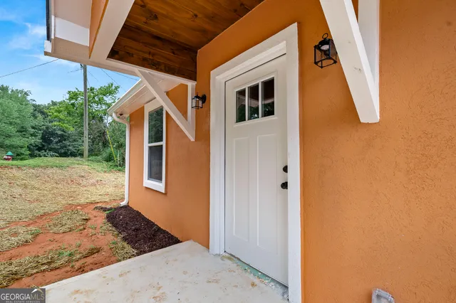 a view of a house with backyard and trees