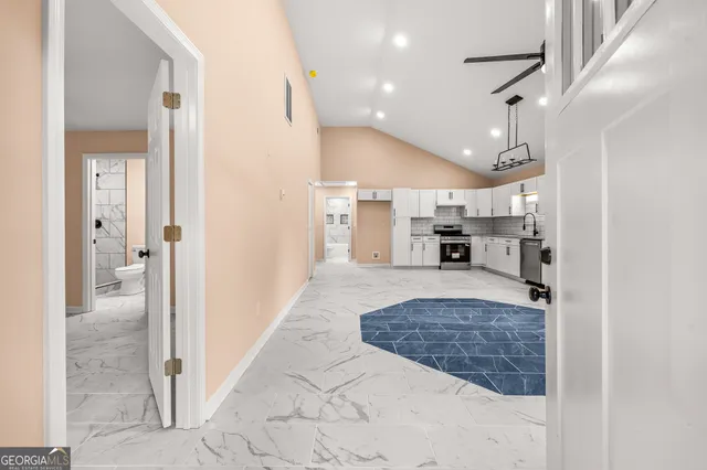 a large bedroom with a large bed and chandelier