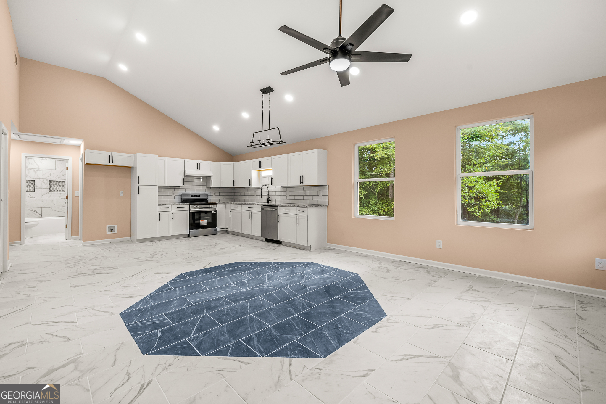 596 Watson Street Toccoa, GA 30577 - Photo 5 of 25 a large bedroom with a large bed and chandelier