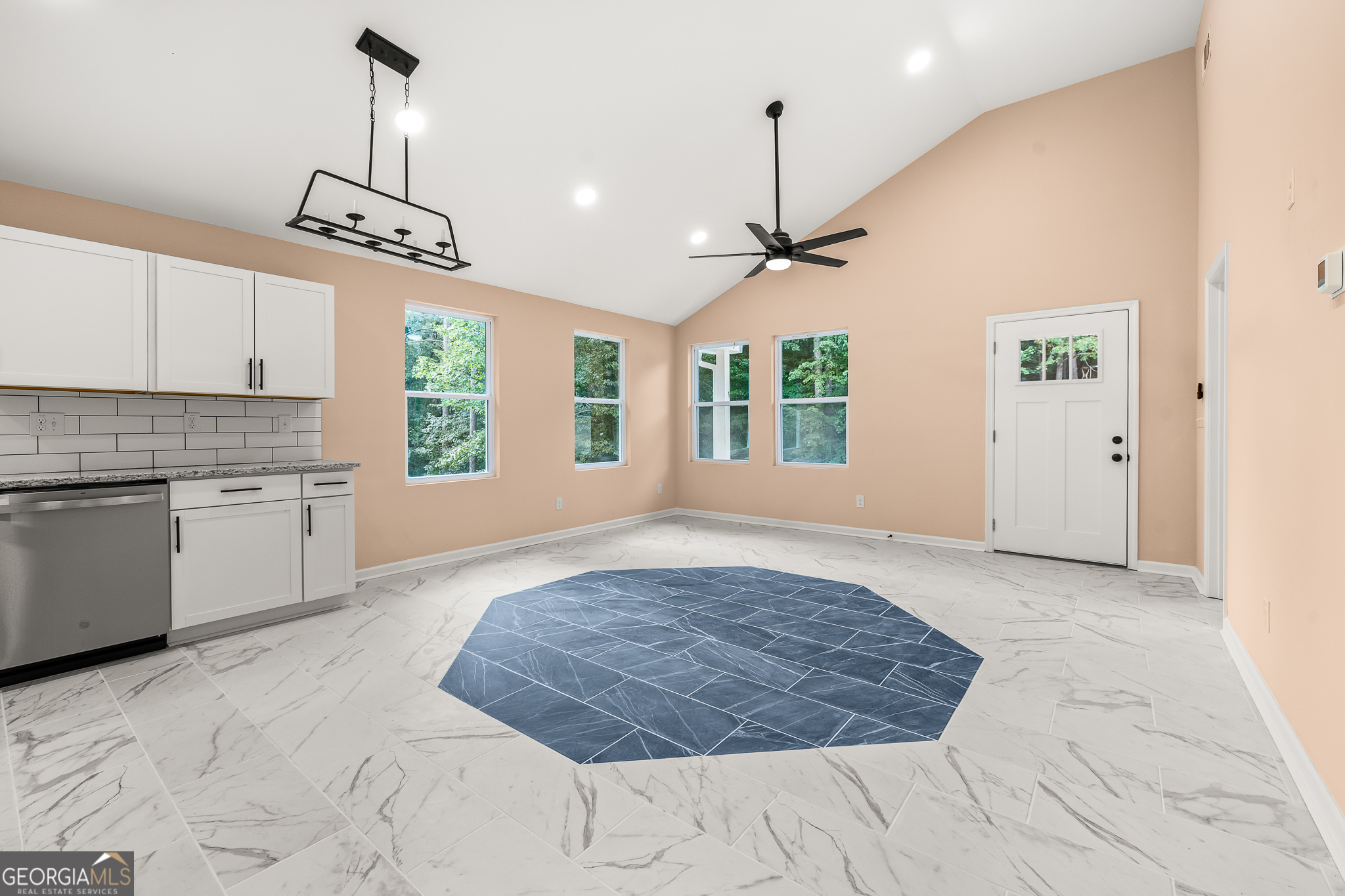 596 Watson Street Toccoa, GA 30577 - Photo 6 of 25 a view of an empty room with a kitchen and window