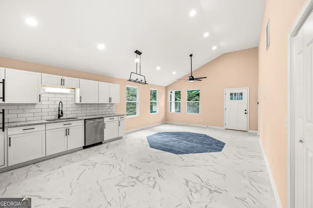 a large kitchen with kitchen island a sink stainless steel appliances and cabinets