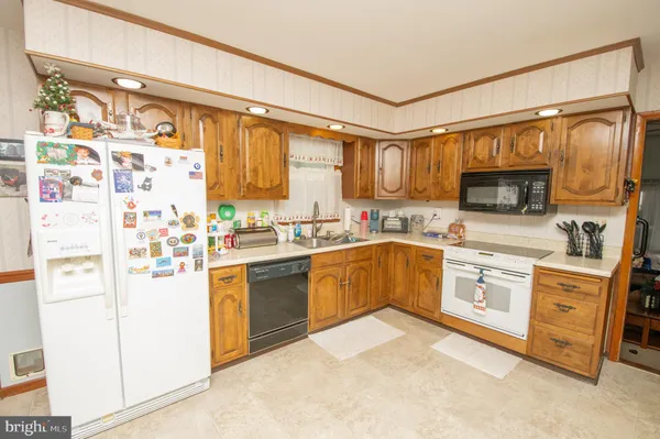 a kitchen with stainless steel appliances a refrigerator sink and microwave