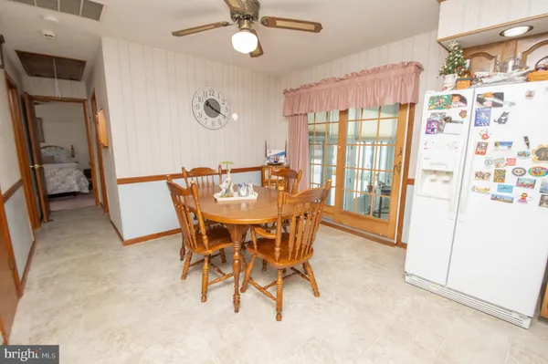 a dining room with furniture and a window