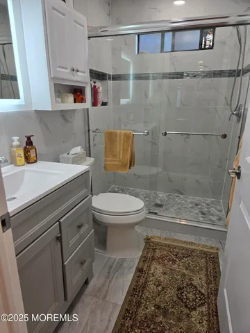a bathroom with a toilet and a shower