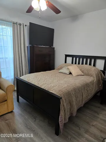 a large bedroom with bed and a chandelier