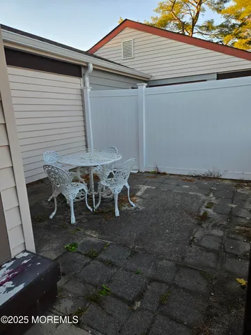 a backyard of a house with table and chairs