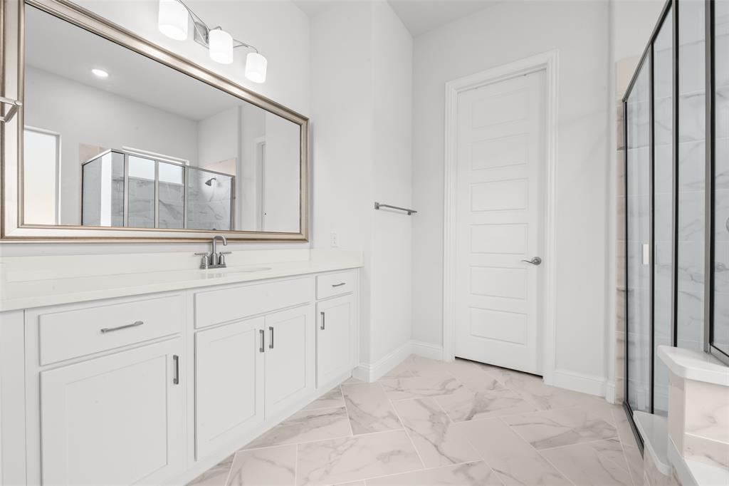 1712 Birch Street Mansfield, TX 76063 - Photo 17 of 35 a bathroom with a sink a light fixture and a mirror