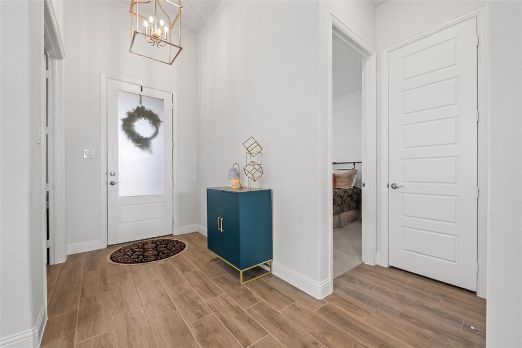 1712 Birch Street Mansfield, TX 76063 - Photo 2 of 35 an empty room with wooden floor cabinet and windows