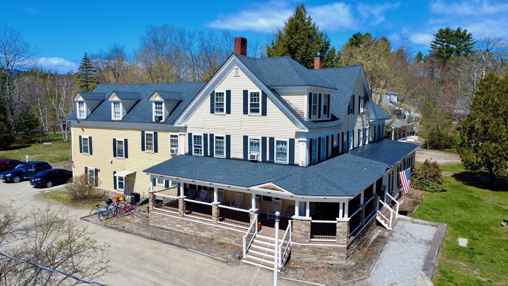 720 Kearsarge Road Conway, NH 03845 - Photo 2 of 21 a aerial view of a house with a yard and balcony