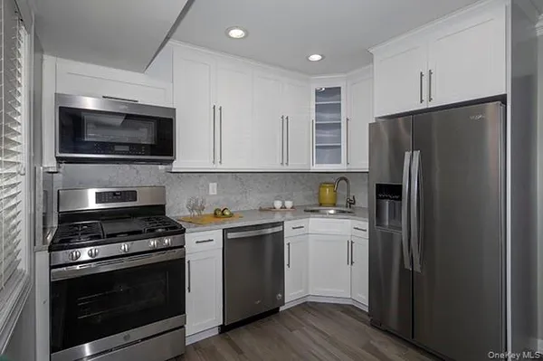 a kitchen with a sink stove and refrigerator
