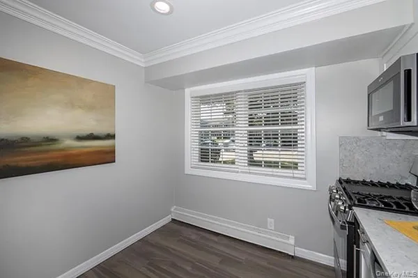 a view of a room with wooden floor and windows